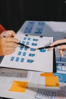 Two people working on a project with a clipboard photo