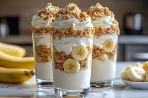 Delicious banana pudding parfaits with whipped cream and cookie crumbs are waiting to be eaten photo