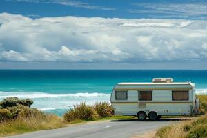 Camper trailer parked near the ocean enjoying breathtaking seascape view photo