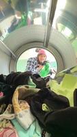 A Vibrant Array of Colorful Laundry Spinning Inside a Washing Machine Drum During a Cycle video