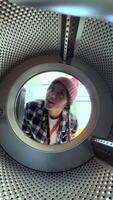 A Surprised Expression Captured Through a Unique Lens of a Dryer in a Colorful Environment video