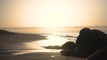 A person walking on the beach with rocks video
