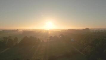 Aerial view of sunrise over a field video