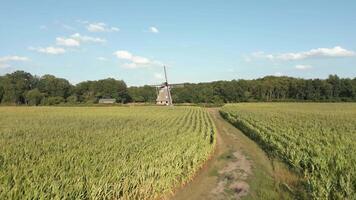 An aerial view of a windmill in a field video