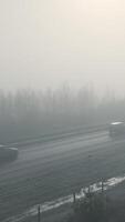 A car driving on a foggy highway with trees in the background video