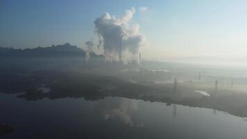 Aerial view of a coal-fired power plant with steam flowing out of the stack in the morning. Mae Moh Power Plant, Lampang. video