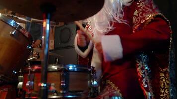 Santa claus joyfully playing drums while enjoying festive christmas music at a lively holiday party, creating a fun atmosphere filled with rhythm and celebration video
