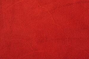 Red suede as a background macro photo. Red suede leather texture photo