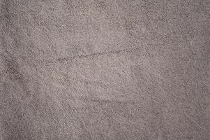 Gray suede leather macro photo as background.