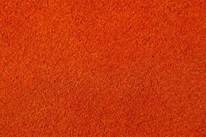 Warm red or orange suede as a background. photo