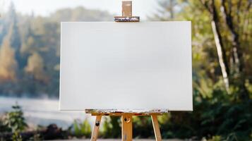 close up mockup white horizontal primed blank canvas stands on wooden tripod against lake or river background sunny day photo