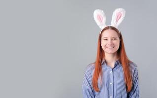woman rabbit ears isolated over light gray color background photo