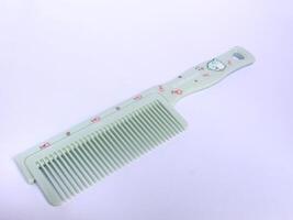 green hair comb isolated on white background, comb to tidy hair photo