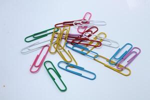 Paper clips with various colors isolated on white background photo