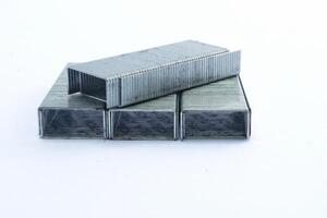 stacked metal staples for stapler isolated on white background, office equipment photo