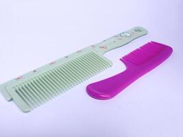 Two hair combs with different designs isolated on white background photo