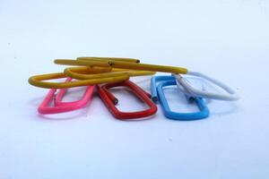 Paper clips with various colors isolated on white background, paper clip tool photo