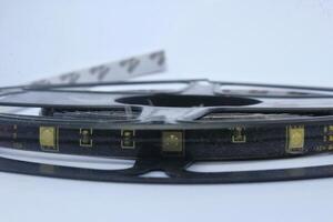 RGB LED strip light ribbon roll isolated on white background. colorful RGB lights photo