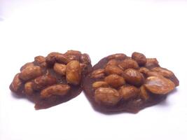 Traditional Indonesian cake made from brown sugar and nuts isolated on white background photo