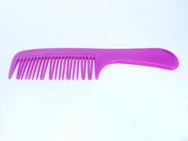 small purple hair comb isolated on white background photo