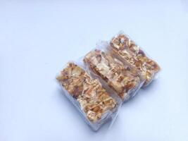 Indonesian traditional cake made from peanuts and sesame isolated on white background photo