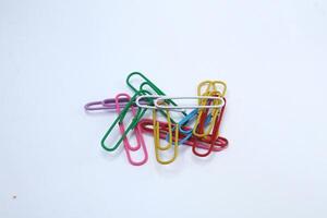 Paper clips with various colors isolated on white background, paper clip tool, office supplies photo