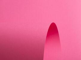 Pink paper background with a smooth matte finish and soft pastel tones. Vibrant magenta, mauve, and photo