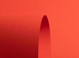 Fiesta red and orange paper background with a matte finish and smooth, curved folds forming elegant photo