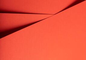 Fiesta red and orange paper background with a matte finish and intersecting, smooth layers. Vibrant, photo