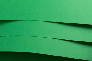 Eden green paper background with layered, curved sheets and a smooth matte finish. Vibrant, soft photo