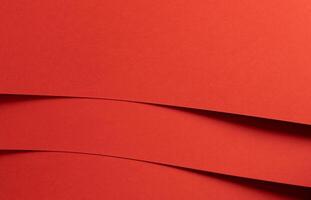 Fiesta red and orange paper background with curved, smooth layers and a matte finish. Rich, photo