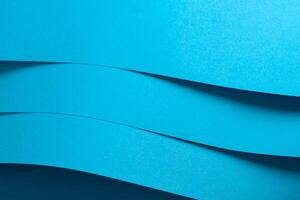 Blue paper background with a smooth matte finish and layered edges. Vibrant pastel tones and a photo