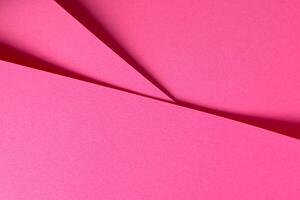 Pink yarrow paper background with a matte finish and subtle fibers creating a textured surface. Bold photo