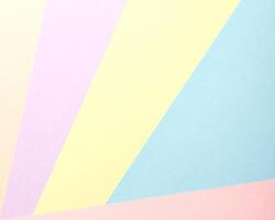 A pastel abstract geometric background featuring a minimalist arrangement of multicolored paper in photo