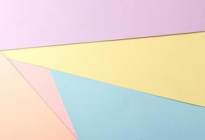 Pastel abstract geometric paper background with lavender, yellow, blue, peach, and pink tones photo