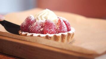 Enjoying a delicious strawberry tart at a cozy cafe video