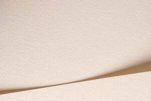 A beige paper background with soft tones and gentle curves, creating a minimalist and natural photo