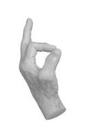 Elderly female hand with wrinkled skin showing an OK gesture, symbolizing approval, success, and photo
