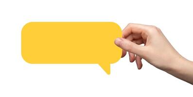 Hand holding a yellow speech bubble, symbolizing communication, dialogue, and sharing opinions. photo