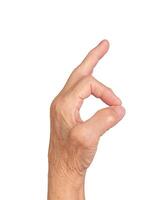 Elderly hand making OK gesture, thumb and finger forming a circle, symbolizing approval, success, photo