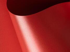 Shiny red paper with a glossy, luxurious surface and elegant sheen. Festive and textured background photo