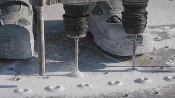 Construction workers use drills on a concrete surface video