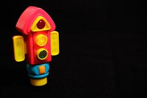 Traffic Light Toy flashing yellow light on Dark Background photo