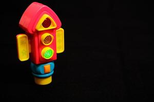 Traffic Light Toy flashing green light on Dark Background photo