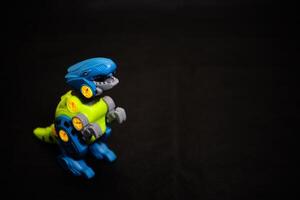 Robot T-Rex Toy on black Background - Mechanical Dinosaur photo