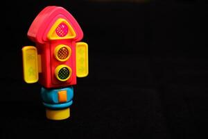 Traffic Light Toy flashing red light on Dark Background photo
