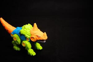 Colorful Toy Dinosaur on Black background - Modern Kids Play photo