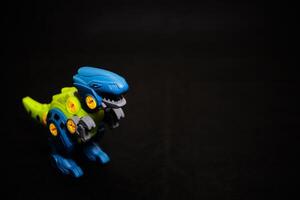 Robot T-Rex Toy on Dark Background - Mechanical Dinosaur photo
