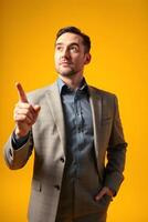 A man in a suit pointing at something photo