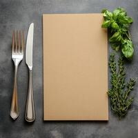 A blank menu with a knife and fork on a table photo